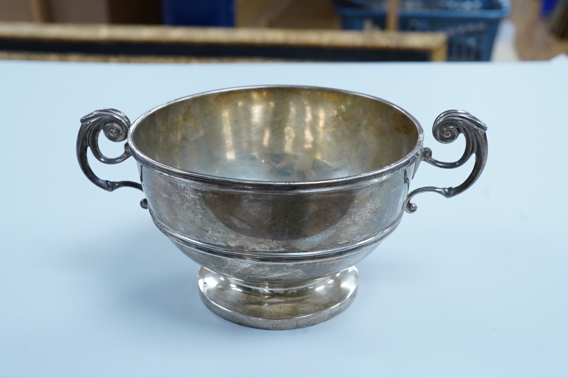 An Edwardian silver two handled pedestal bowl, by Lambert & Co, London, 1909, with later engraved inscription, diameter 10.5cm excluding the handles, 7.2oz.